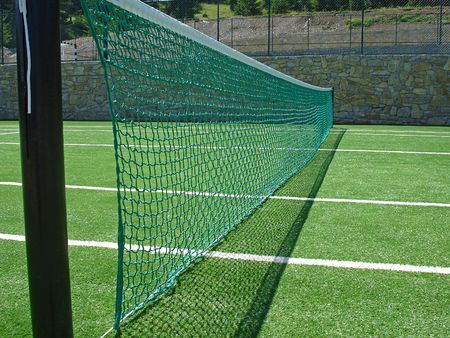  tennis net on empty tennis field                              の写真素材