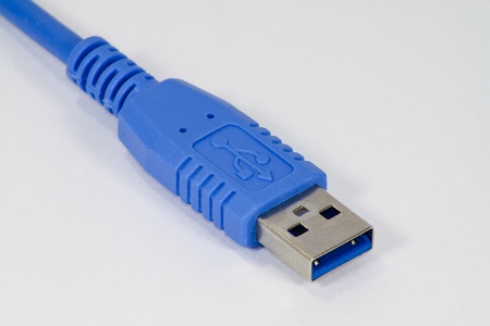 Blue USB connector on white backgroundの写真素材