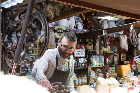 Paris, France-November 22, 2015: The unidentified butcher selling corsica's delicatessen at Christmas market located on Champs Elysees avenue in Paris, France.のeditorial素材