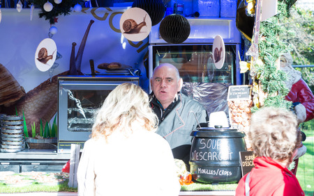 Paris; France-November 28, 2015 : The unidentified seller of snail soup at Christmas market on Champs Elysees avenuein Paris, France.のeditorial素材