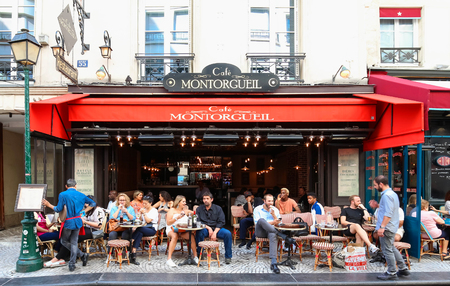 People passes by a cafe on Rue Montorgueil street, Paris, France.のeditorial素材