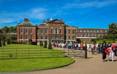 The Kensington palace in Hyde park view at sunny day with lots of people walking and resting in the parkのeditorial素材