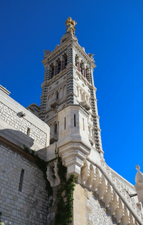 The scenic stone bell tower of Notre Dame de la Garde Basilica, Marseille, France.の写真素材