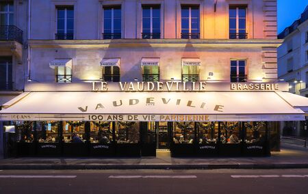 The traditional French brasserie Le Vaudeville at night. It is located near Brogniart palace in Paris, France.のeditorial素材