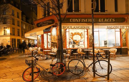 The French traditional bakery and pastry shop Au Petit Versailles du Marais located in historical Marais quarter at night, Paris, France.のeditorial素材
