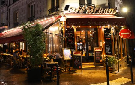 The Cafe Bruant is a cafe in the Montmartre at rainy night , Paris, France.のeditorial素材