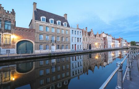 Scenic city view of Bruges canal with beautiful medieval colored houses and reflections in the evening.の写真素材