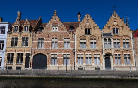 Scenic city view of Bruges canal with beautiful medieval colored houses .の写真素材