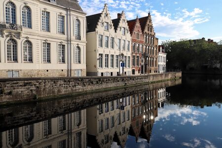 Scenic city view of Bruges canal with beautiful medieval colored houses and reflections.の写真素材