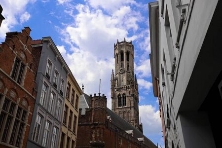 The tower of belfry and traditional buildings with lamp post in the foreground, Bruges , Belgium.の写真素材