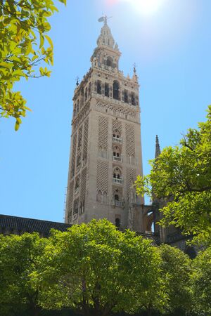 Famous tower of Giralda, Islamic architecture built by the Almohads and crowned by a Renaissance bell tower with the statue of Giraldillo at its highest point, Seville Cathedral.の写真素材