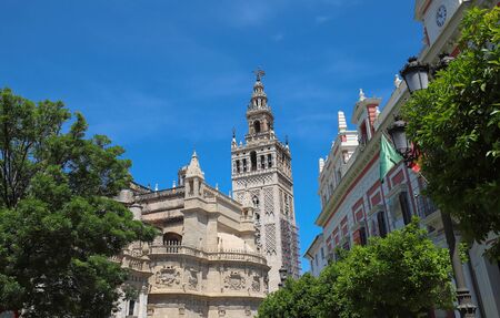 Famous tower of Giralda, Islamic architecture built by the Almohads and crowned by a Renaissance bell tower with the statue of Giraldillo at its highest point, Seville Cathedral.の写真素材