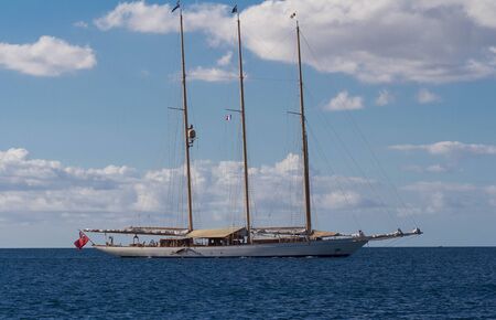 A three masted sailboat moored in a calm Caribbean harbor, Martinique island, French West Indies.の写真素材
