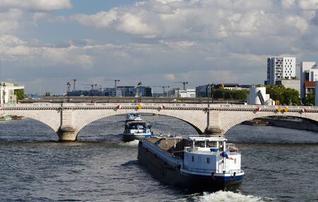 The Tolbiac bridge , Seine river and barges, Paris, France.の写真素材