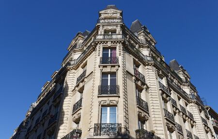 Traditional French house with typical balconies and windows. Paris, France.の写真素材