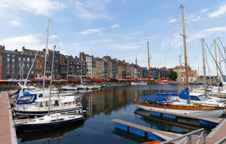 Honfleur harbour in Normandy, France. Color houses and their reflection in water.の写真素材