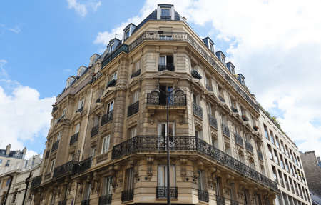 Traditional French house with typical balconies and windows. Paris.