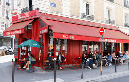 View of typical cafe in Paris. Montmartre area is most popular destinations in Paris, has lots of cozy cafes, restaurants, bistros, night clubs and artistic studios.のeditorial素材