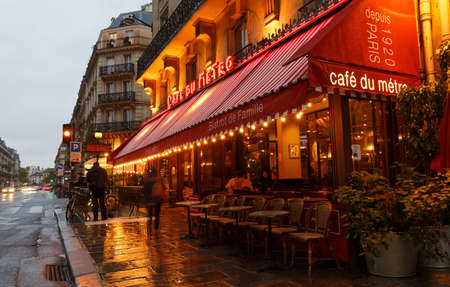 View of typical Parisian cafe du Metro at rainy night . It is located near famous Saint Germain boulevard in Paris, France.のeditorial素材
