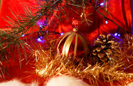Christmas decoration: baubles with cones and fir tree branches isolated on red backgroundの写真素材
