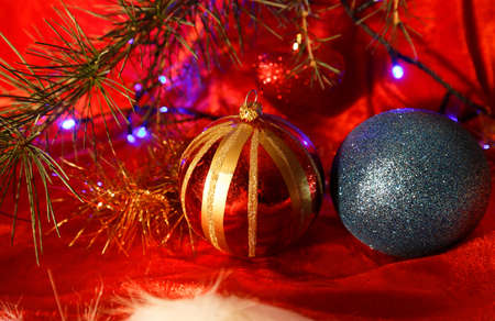 Two christmas balls on red background with fir branch.の写真素材