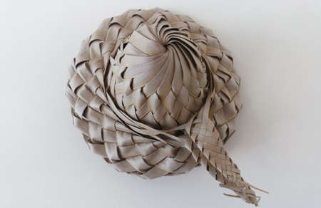 Bakoua hat on the white background. It is a typical Caribbean Straw Hat, made from the leaf of the tree.の写真素材