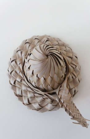 Bakoua hat on the white background. It is a typical Caribbean Straw Hat, made from the leaf of the tree.の写真素材