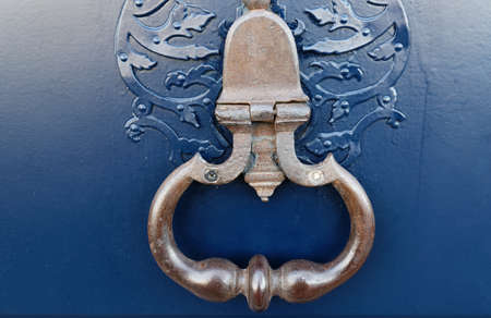 European Vintage old metal wrought iron door knocker. Design detail. Paris.