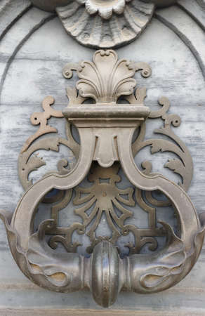 European Vintage old metal wrought iron door knocker. Design detail. Paris.の写真素材