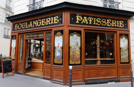 The vintage bakery and cake shop Academie du pain located in 14th district of Paris. The front shows the ornaments of woodwork , set under glass, with gold leaf.のeditorial素材
