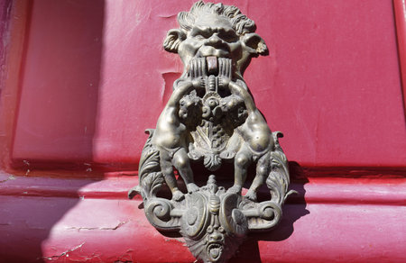 European Vintage old metal wrought iron door knocker. Design detail. Paris.の写真素材