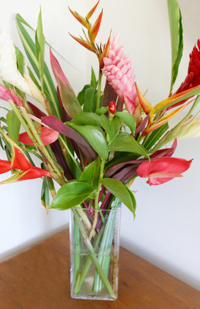 The colorful tropical flowers bouquet arrangement on wooden background.の写真素材