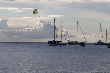 The catamaran and sailboats anchored in waters of caribbean beach.の写真素材