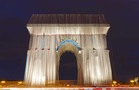 The Triimphal Arch in Paris swathed in silvery blue fabric and red rope as a posthumous project planned by the artist Christo. Paris, France.のeditorial素材