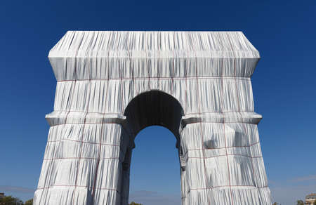 The Triimphal Arch in Paris swathed in silvery blue fabric and red rope as a posthumous project planned by the artist Christo. Paris, France.のeditorial素材