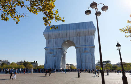 The Triimphal Arch in Paris swathed in silvery blue fabric and red rope as a posthumous project planned by the artist Christo. Paris, France.のeditorial素材