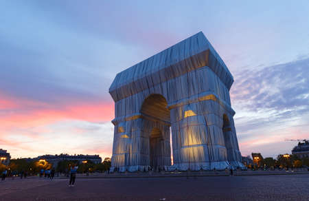 The Triimphal Arch in Paris swathed in silvery blue fabric and red rope as a posthumous project planned by the artist Christo. Paris, France.のeditorial素材