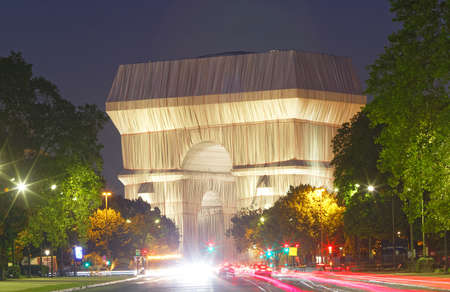 The Triimphal Arch in Paris swathed in silvery blue fabric and red rope as a posthumous project planned by the artist Christo. Paris, France.のeditorial素材