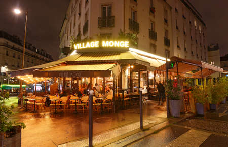 The French traditional restaurant Village Monge located in Latin quarter at night, Paris, France.のeditorial素材