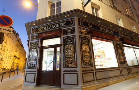 The vintage bakery and cake shop located in 10th district of Paris at famous Parmentier avenue at night .のeditorial素材