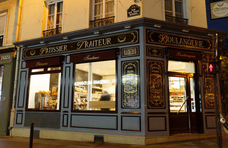The vintage bakery and cake shop located in 10th district of Paris at famous Parmentier avenue at night .のeditorial素材