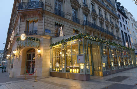 The famous French luxury bakery and sweets shop La Duree decorated for Christmas on Champs Elysees avenue, Paris, France.のeditorial素材