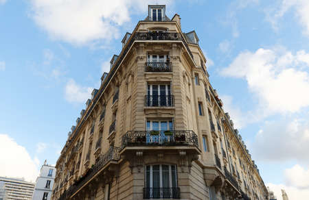 The facade of traditional French house with typical balconies and windows. Paris.の写真素材