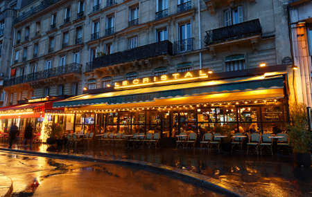 The traditional French restaurant Le Cristal at rainy night . It located in 17 th district of Paris near Triumphal Arch , Paris, France.のeditorial素材