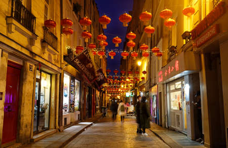 Au Maire street located in Marais district of Paris decorated with traditional red lanterns for Chinese New Year celebration in 3th district of city.のeditorial素材