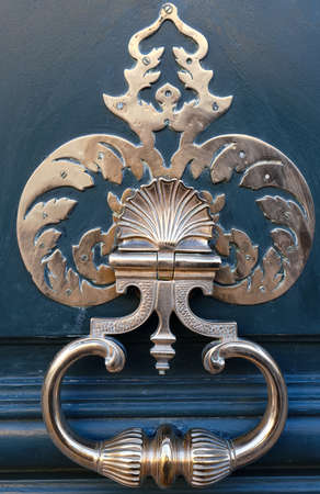 European Vintage old metal wrought iron door knocker. Design detail. Paris.の写真素材