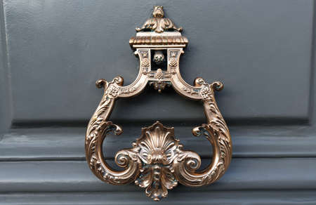 European Vintage old metal wrought iron door knocker. Design detail. Paris.の写真素材