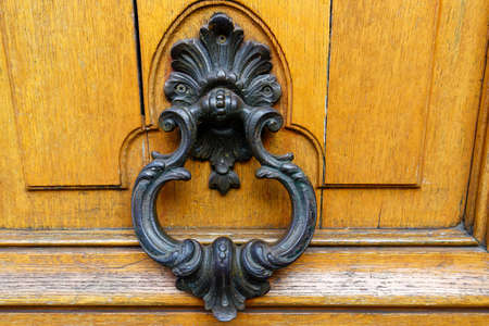European Vintage old metal wrought iron door knocker. Design detail. Paris.の写真素材