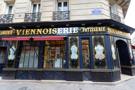 The vintage bakery and cake shop Au pain retrouve located in 6th district of Paris. The front shows the ornaments of woodwork , set under glass, with gold leaf.のeditorial素材