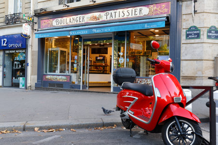 The vintage bakery and cake shop Marceaux and vintage scooter in the foreground . It located at Reuilly boulevard in 12th district of Paris. France.のeditorial素材